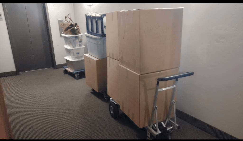 Hand trucks loaded with boxes lining up on the elevator