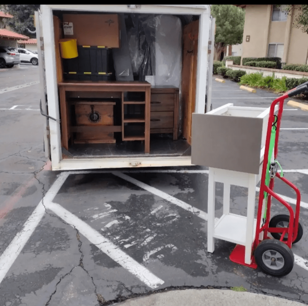 Moving truck loaded with tables and other furnitures