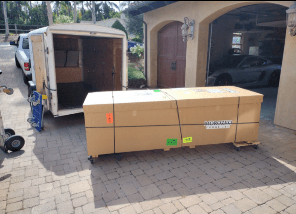 A big box and a moving truck outside a house
